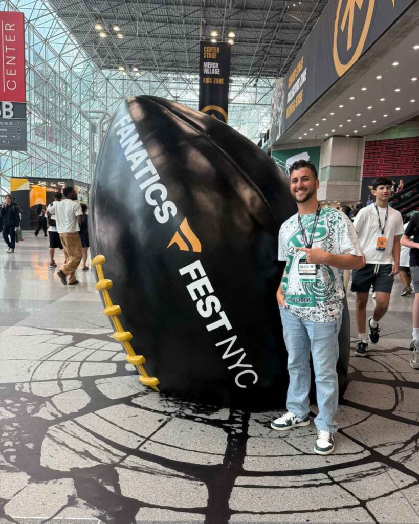 A fan poses with one of Smash Design's huge foam sculptures created for Fanatics Fest 2026